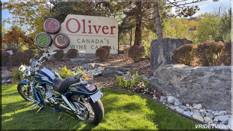 motorcycle at welcome to oliver sign