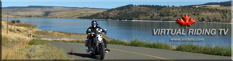 motorcycle rider with lake in background